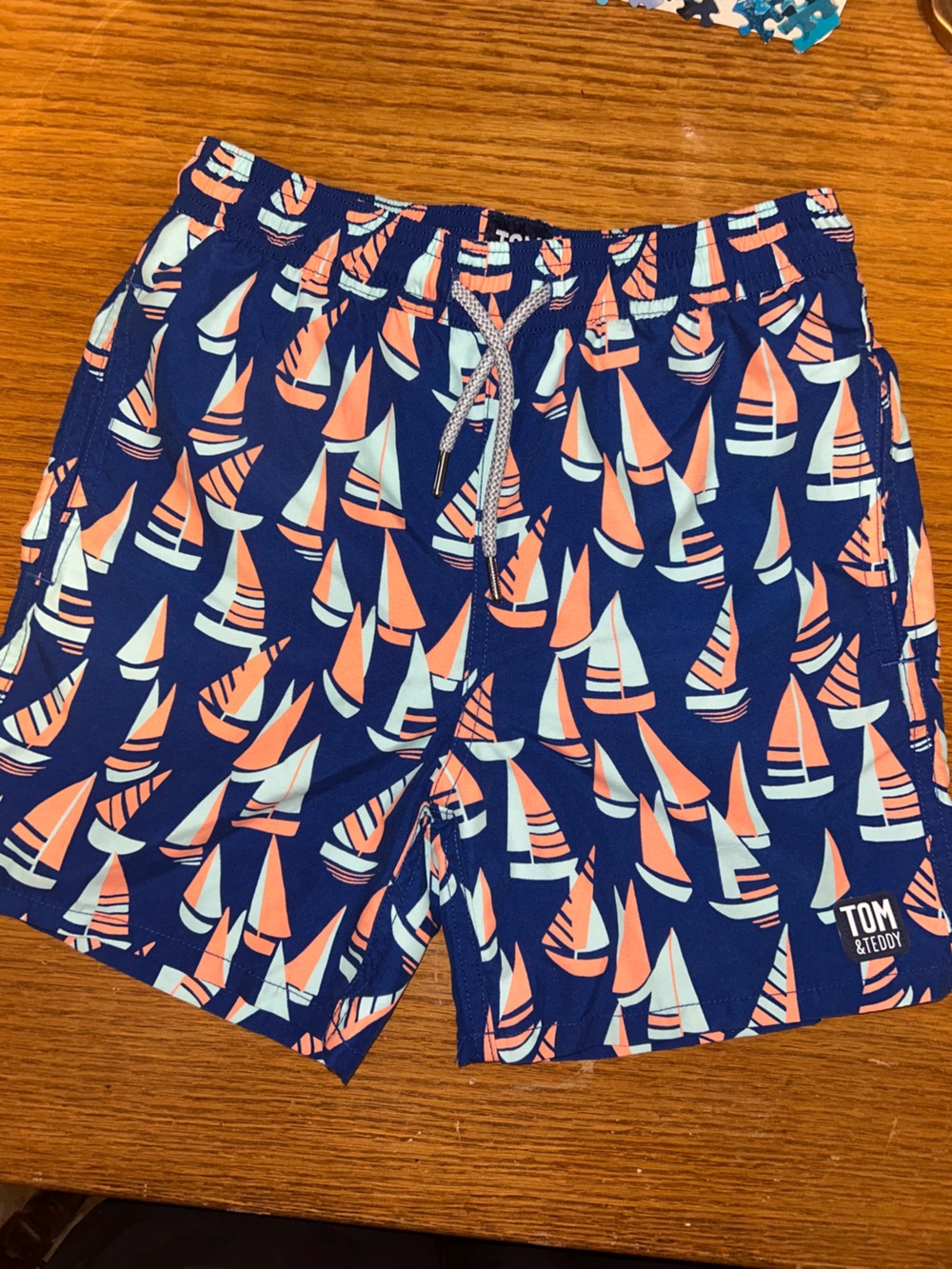 Boys Tom & Teddy Navy Swim Trunks with Coral and Light Blue Sailboat Motif